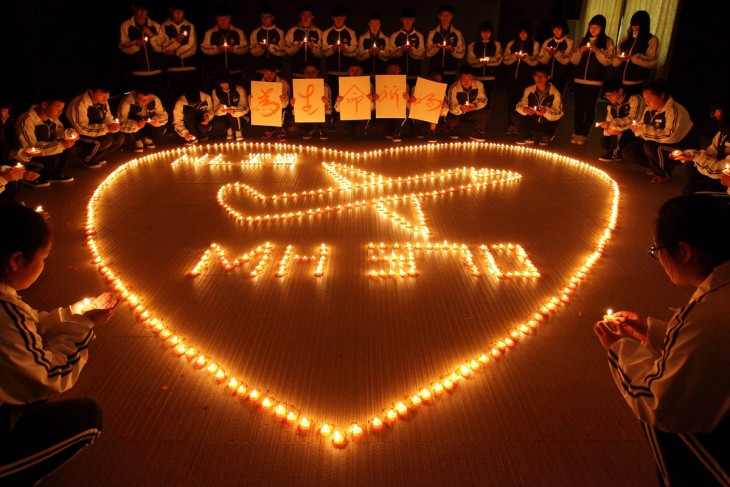 ZHUJI, CHINA - MARCH 10:  (CHINA OUT) Students from an international school in east China city Zhuji pray for the passengers onboard Malaysia Airlines flight MH370 by lighting candles on March 10, 2014 in Zhuji, China. Malaysia Airline flight MH370 from Kuala Lumpur to Beijing and carrying 239 onboard was reported missing after the crew failed to check in as scheduled while flying over waters between Malaysia and Ho Chi Minh City in Vietnam.  (Photo by ChinaFotoPress/ChinaFotoPress via Getty Images)